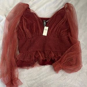 Anthropologie lace sleeved blouse in color wine. Smocked/synched waist